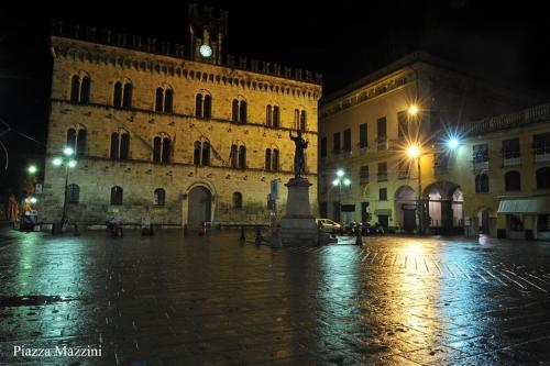 a building with a statue in the middle of a street at night at Hotel Dell'Orto in Chiavari