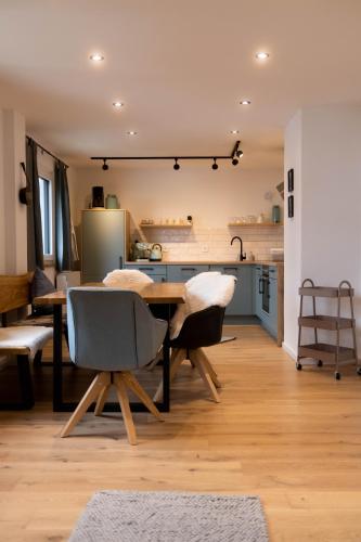 a kitchen and dining room with a table and chairs at s'Manggei Gosau in Gosau