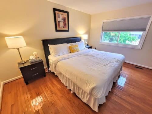 a bedroom with a large bed and a window at Nice 2BDR near Airport with fast WiFi / Metro / Parking in Herndon