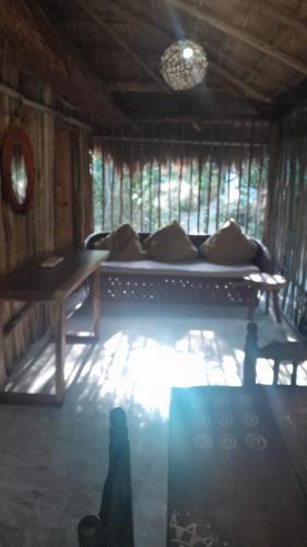 a person standing in a room with a bed at Aldea Yuyu in Tulum