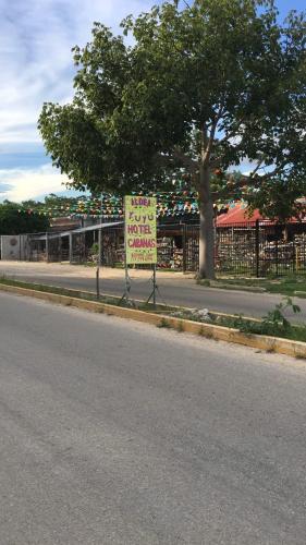 a sign on the side of a street with a store at Aldea Yuyu in Tulum