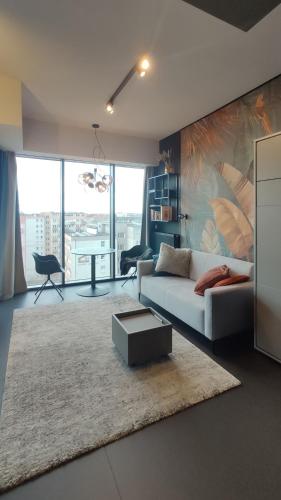 a living room with a couch and a table at Hanza Tower Studio in Szczecin