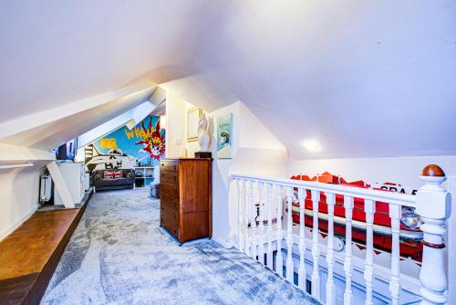 a white room with a crib and a bedroom at Entire Artistic Open-Plan Top Floor Apartment in Westcliff-On-Sea