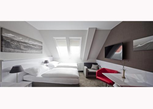 a bedroom with a bed and a couch and a table at Top Penzión Marína in Dolný Kubín