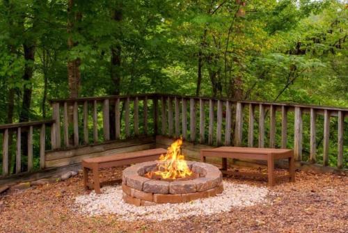 a firepit with two benches and a fire pit with two benches at Blue Beary Delight Newly renovated Near Everything in Sevierville