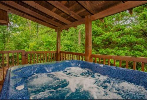 a jacuzzi tub on the back of a porch at Blue Beary Delight Newly renovated Near Everything in Sevierville