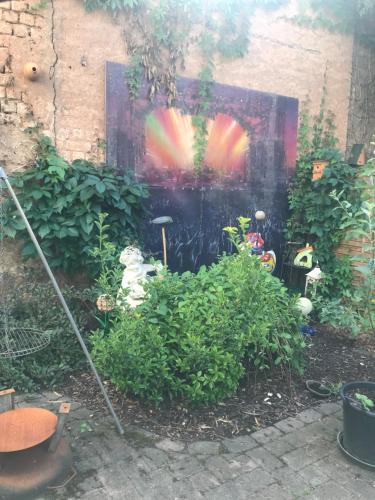 a garden with a painting on the side of a building at Kamoro in Trier