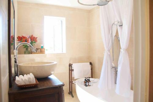 a bathroom with a tub and a sink and a bath tub at Canal view 2 bedrooms end of terrace in Chichester