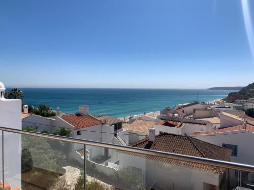 a view of the ocean from the balcony of a building at Casa Pedro in Salema - Oceanview & beach in Salema