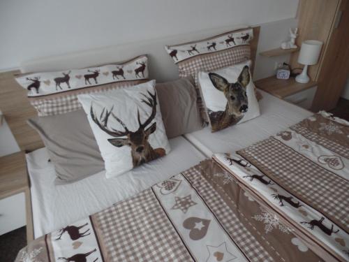 a bed with two stuffed deer heads on it at Am Waldrand in Bayerisch Eisenstein