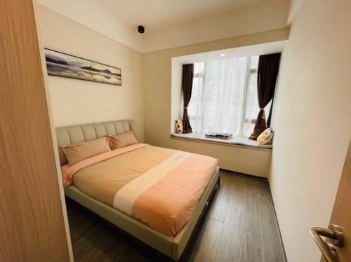 a small bedroom with a bed and a window at Embassy Access Golf Apartment in Kigali