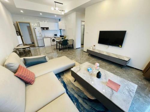 a living room with a couch and a tv at Embassy Access Golf Apartment in Kigali