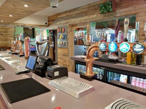 a bar with a counter top with a barber shop at Golden Sands Caravan Hire Ingoldmells- FREE in caravan wifi- Access included to the on site club house, sports bar, arcade, coffee shop We have beach access, a fishing lake and a laundrette in Ingoldmells