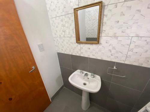 a bathroom with a sink and a mirror at Casa May - A 15 min del Aeropuerto in Barrio Esteban Echeverría