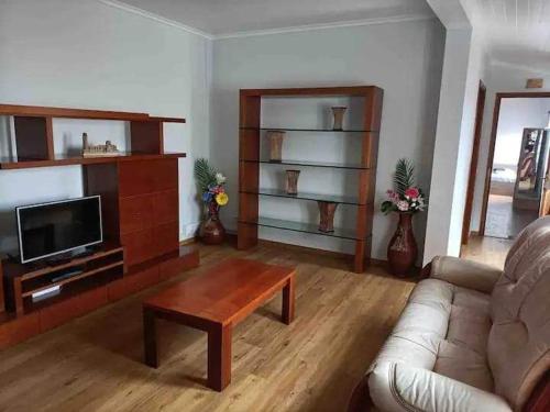 a living room with a couch and a coffee table at Azores House in Ponta Delgada