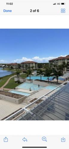 a screenshot of a picture of a building with two pools at Pelican Waters Resort One Bedroom Apartment in Pelican Waters