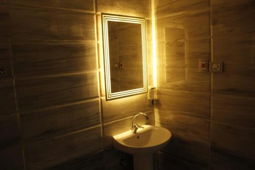 a bathroom with a sink and a mirror at METROPOLITANO in Cairo