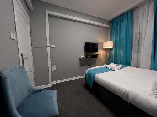 Un ou plusieurs lits dans un hébergement de l'établissement Pyramids Gate Hotel
