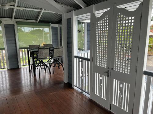 a screened in porch with a table and chairs at Old Queensland Charm Entire upper level in Brisbane