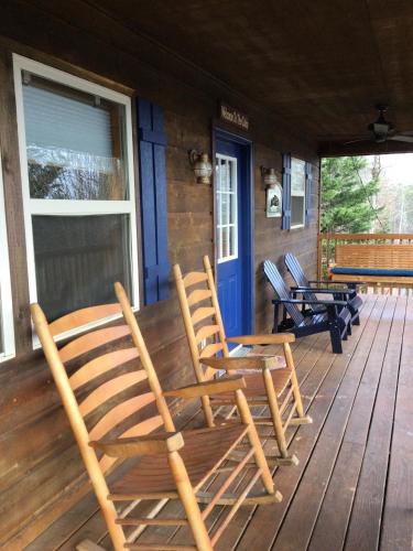 a group of chairs sitting on the front porch of a house at Blue Beary Delight Newly renovated Near Everything in Sevierville