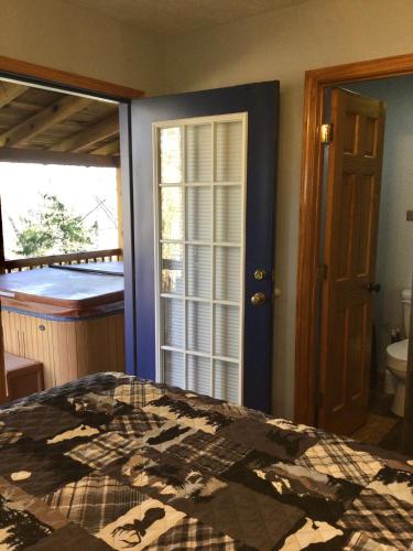 a bedroom with a bed and a bathroom at Blue Beary Delight Newly renovated Near Everything in Sevierville