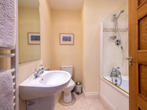 a bathroom with a sink and a toilet and a shower at Kenmare Townhouse in Kenmare