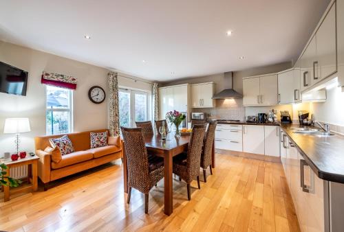 a kitchen and living room with a table and a couch at Kenmare Townhouse in Kenmare