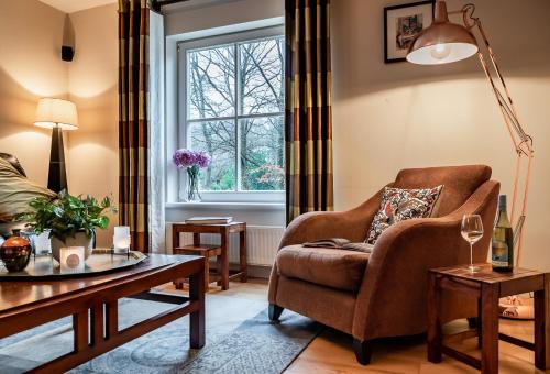 a living room with a chair and a table at Kenmare Townhouse in Kenmare