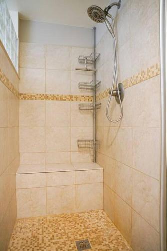 a shower with a shower head in a bathroom at 4BR/2.5BA Home boasting 2400sqft and Eat-in KTN in Toledo