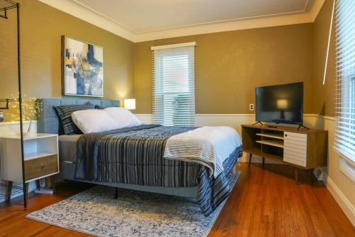 a bedroom with a bed and a television in it at 4BR/2.5BA Home boasting 2400sqft and Eat-in KTN in Toledo