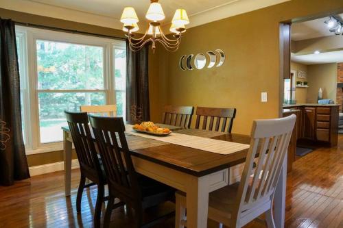 a dining room with a wooden table and chairs at 4BR/2.5BA Home boasting 2400sqft and Eat-in KTN in Toledo