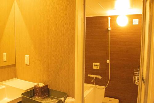 a small bathroom with a toilet and a shower at Mt Fuji View Villa Fujino Kirameki Fujigotemba in Gotemba