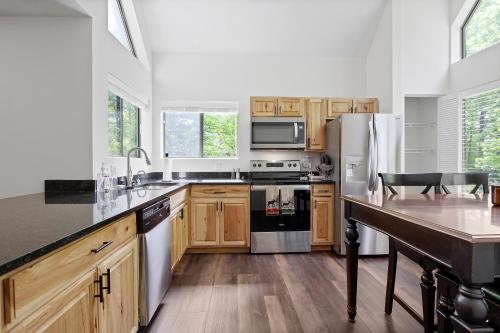 a kitchen with wooden cabinets and stainless steel appliances at Charming Getaway l recently renovated l Hidden Valley l 4BR+3Bath l Hot Tub in Somerset
