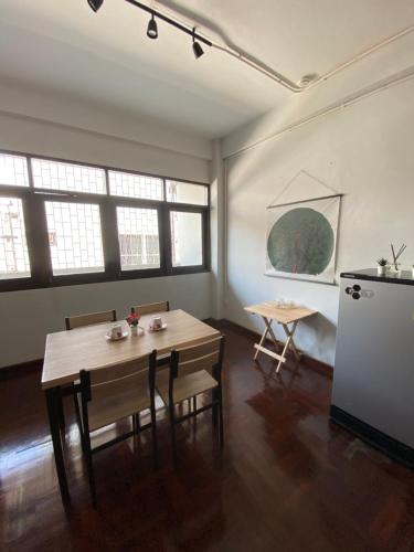 a room with a table and chairs and a refrigerator at Freedom8 in Khlong San