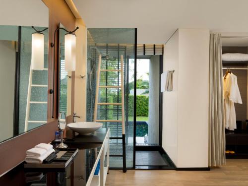a bathroom with a sink and a mirror at The ShellSea Krabi I Luxury Beach Front Resort & Pool Villa in Ao Nam Mao