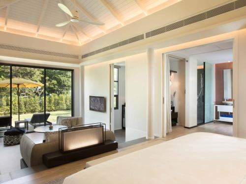 a living room with a ceiling fan and a couch at The ShellSea Krabi I Luxury Beach Front Resort & Pool Villa in Ao Nam Mao