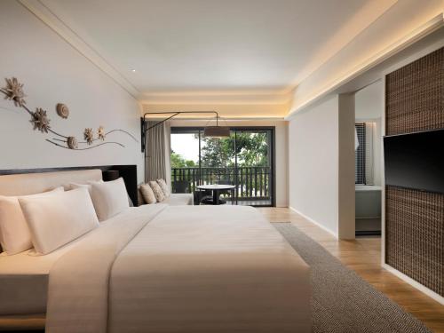 a bedroom with a large bed and a balcony at The ShellSea Krabi-SHA Extra Plus in Ao Nam Mao