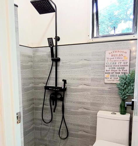 a shower stall in a bathroom with a shower at Dolores Residences Rm Bianca in General Santos