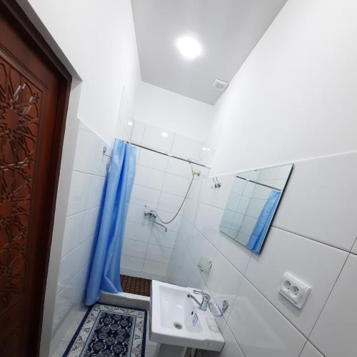 a bathroom with a sink and a shower at Guest House Khiva ,, BOYJON OTA " in Khiva