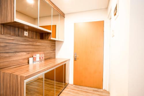 a kitchen with a wooden counter and a door at Menara One Hotel by Menara Santosa in Kartosuro