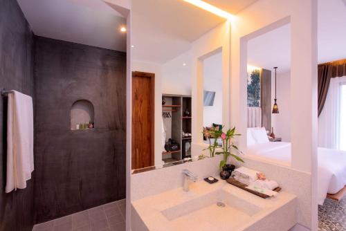 a bathroom with a sink and a large mirror at Siem Reap Palace Hotel & Spa in Siem Reap