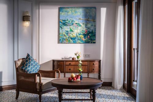 a living room with a chair and a table at The Anam Mui Ne in Mui Ne
