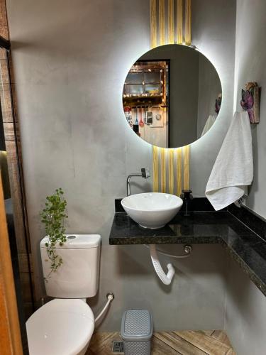 a bathroom with a sink and a toilet and a mirror at Casa aluguel ilha grande,Mar 2 in Abraão