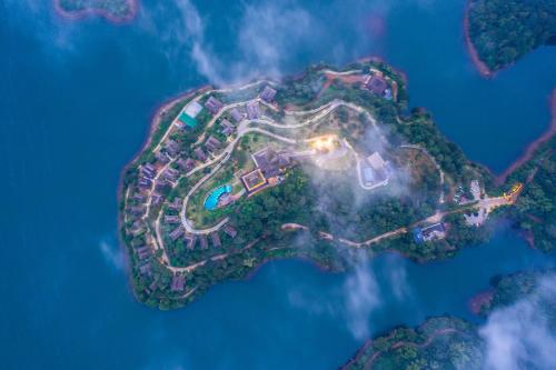 an aerial view of an island in the ocean at night at MOUNTAIN SHADOWS RESORT Wayanad in Wayanad