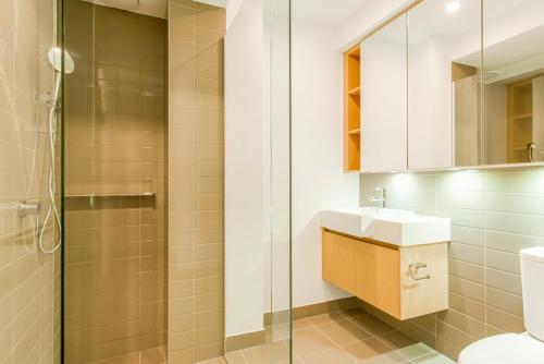 a bathroom with a shower and a sink and a toilet at Bayside Melbourne Apartment in Melbourne