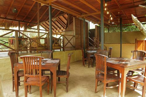 a dining room with wooden tables and chairs at Leopard Nest - Glamping in Yala in Yala