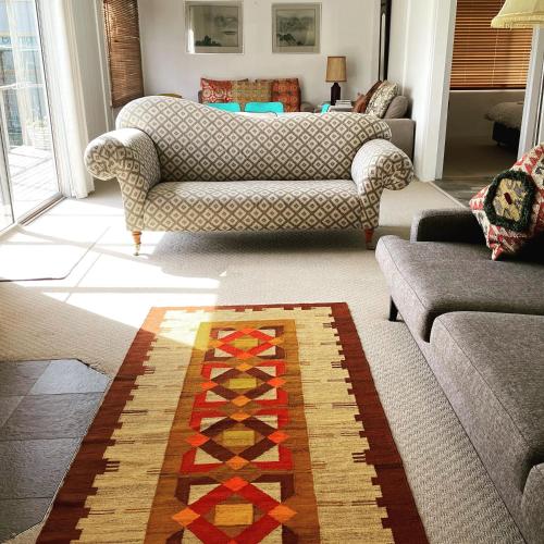 a living room with a couch and a rug at Sisters Beach House in Sisters Beach