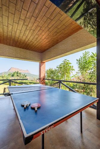 a ping pong table in a room with a view at SaffronStays Althea - 4 BRD Veg Only Villa In Pawna With Jacuzzi In Every Room in Lonavala