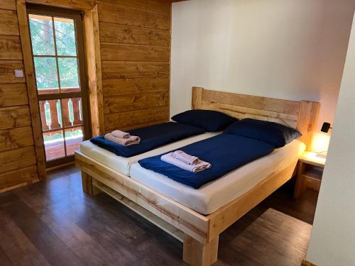 a bedroom with a bed with two towels on it at Chata na přehradě s vlastním wellness in Horní Bečva