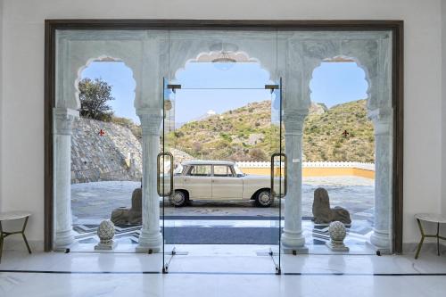 a view of a car through a glass door at Fateh Vilas by Fateh Collection in Udaipur